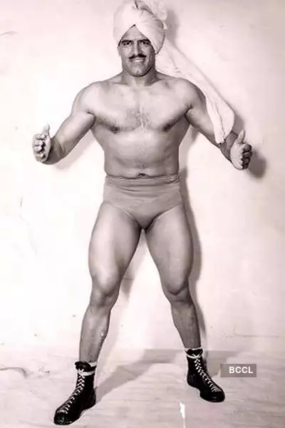 Dara Singh posing as a wrestler in boots and a turban